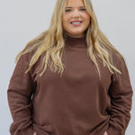 Model in espresso mock neck in 2xl