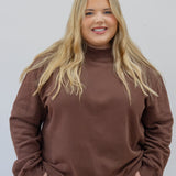 Model in espresso mock neck in 2xl