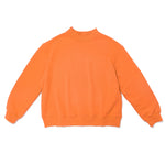 orange mock neck flat lay