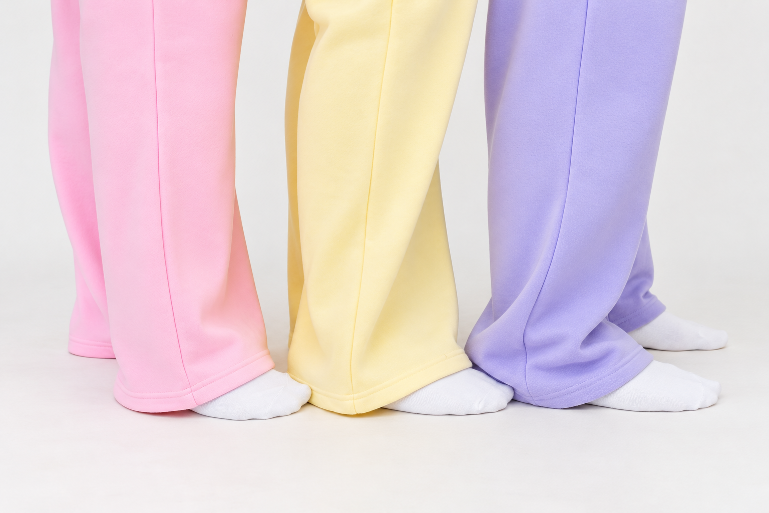 detail shot of hem of sweatpants in 3 colors pink, butter, and lilac