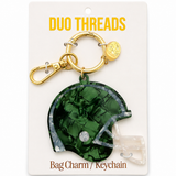 A green football helmet-shaped bag charm keychain with a gold clasp, displayed on a white card labeled 'DUO THREADS Bag Charm / Keychain'.