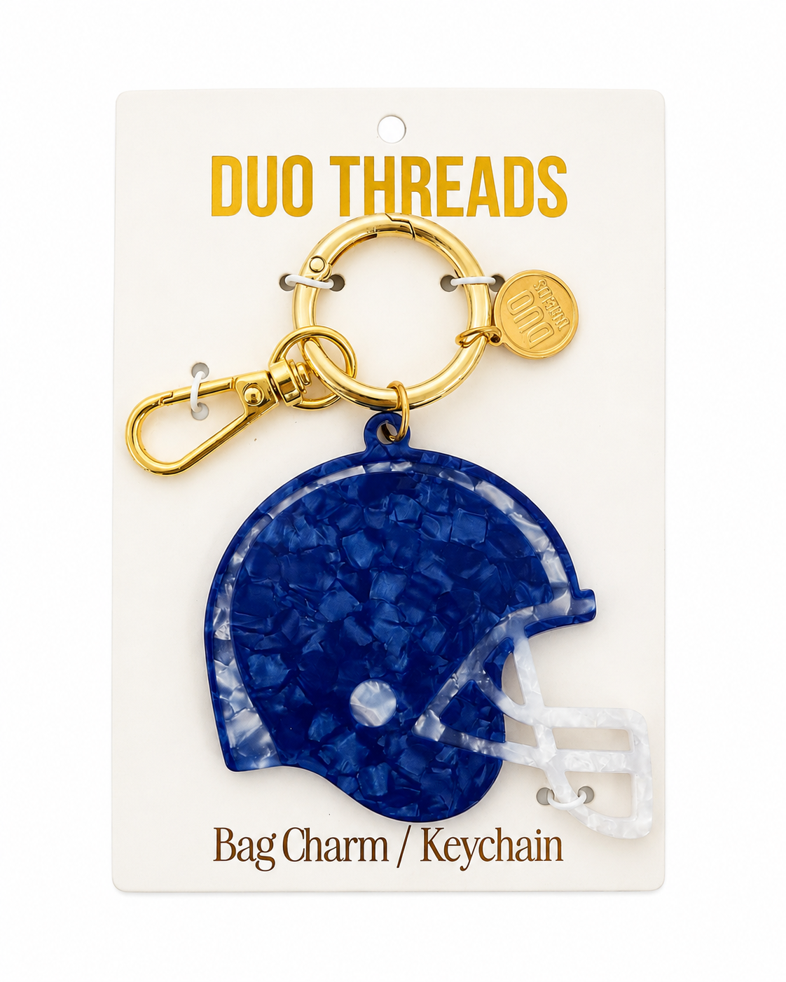 A royal blue football helmet-shaped bag charm keychain by Duo Threads, attached to a gold-tone split ring and clasp, displayed on its white backing card.
