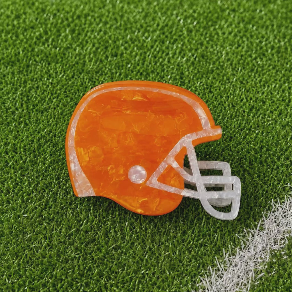 A stop motion video rotating through all the colors of the helmet claw clips on a green turf background